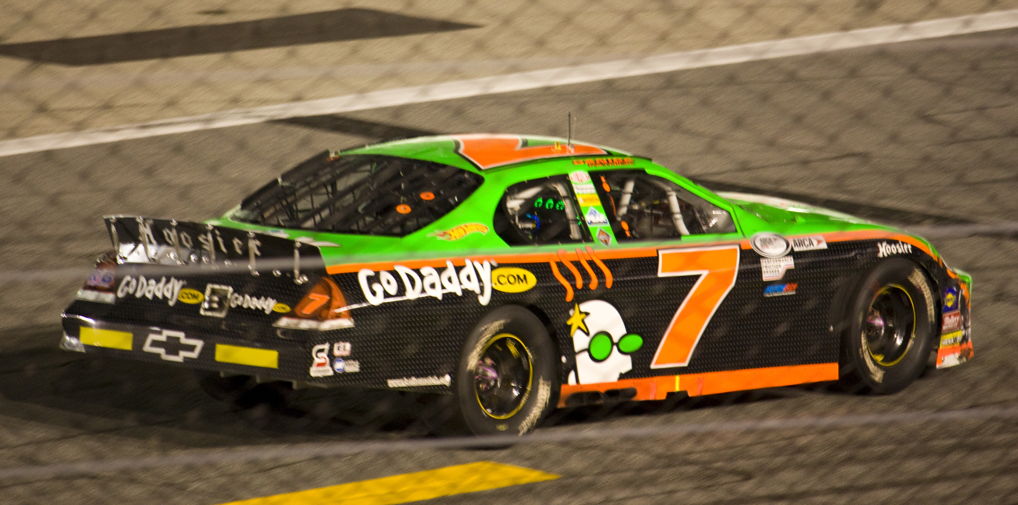 Danica Patrick driving a green-and-orange No. 7 stock car at Daytona International Speedway during the 2010 Lucas Oil Slick Mist 200.