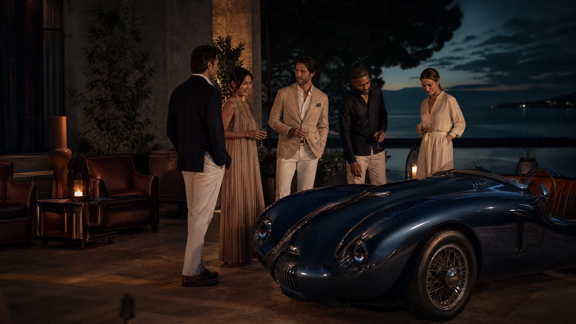 Intimate luxury automotive gathering in a waterfront lounge courtyard