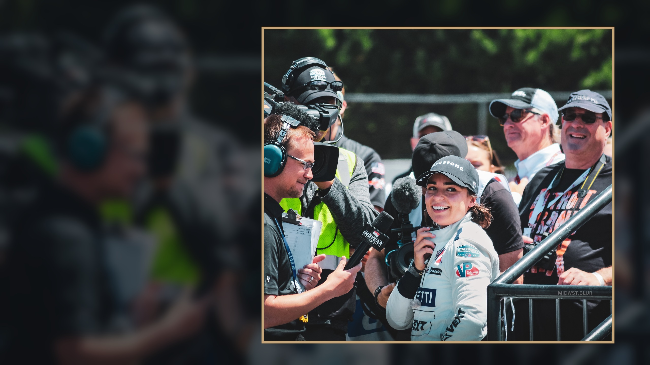 Jamie Chadwick at the 2024 XPEL Grand Prix at Road America, speaking to media in the paddock; career-context photograph, not Le Mans, Genesis, Hypercar, 2026, or Test Day imagery.